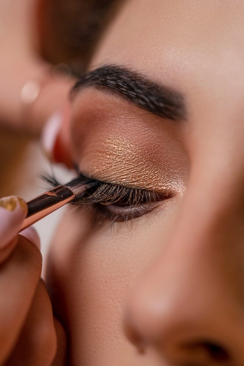 a woman getting her make up done with a brush